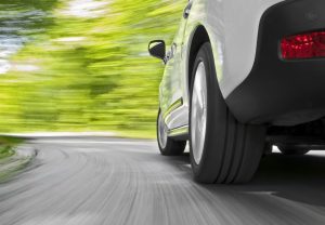 White Car Traveling Turning On Road