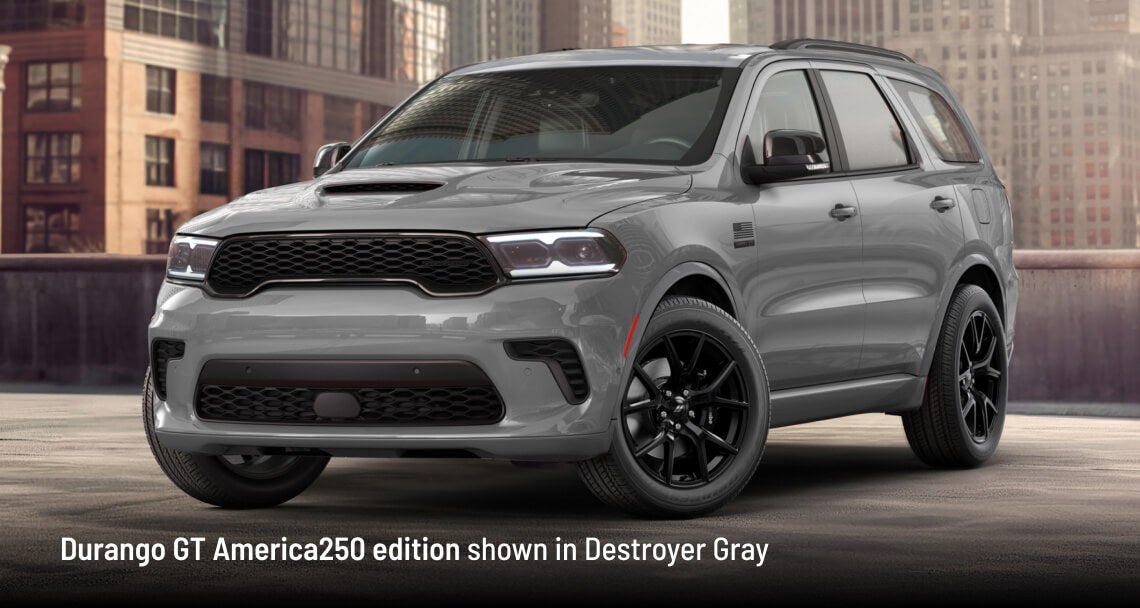 2026 Dodge Durango GT America250 in Destroyer Gray, front three-quarter view in an urban backdrop.