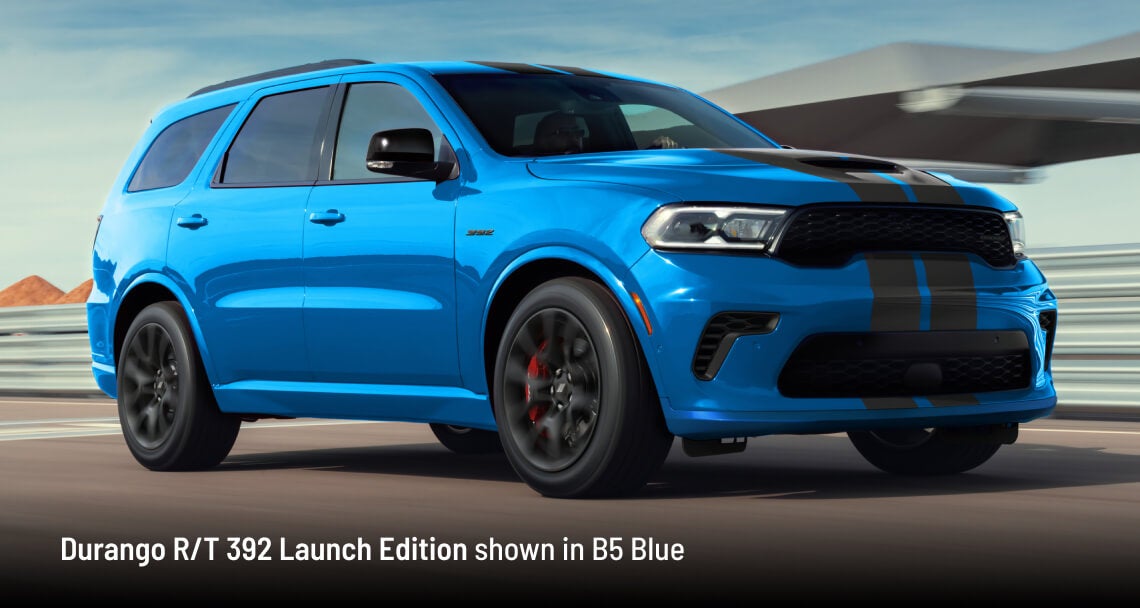 2026 Dodge Durango R/T 392 Launch Edition in B5 Blue, front three-quarter driver-side view in motion on a road.