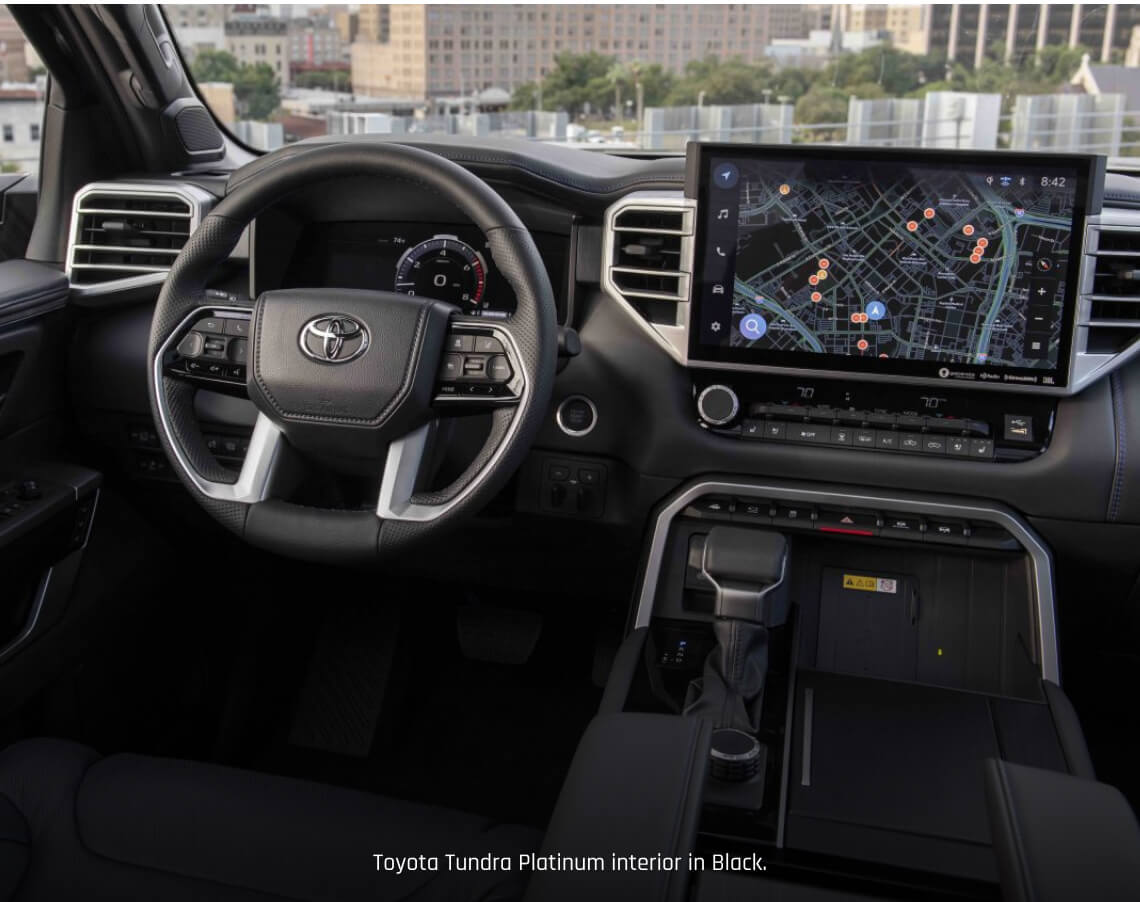 Interior cockpit view of a Toyota Tundra Platinum in Black showcasing the multi-functional steering wheel.