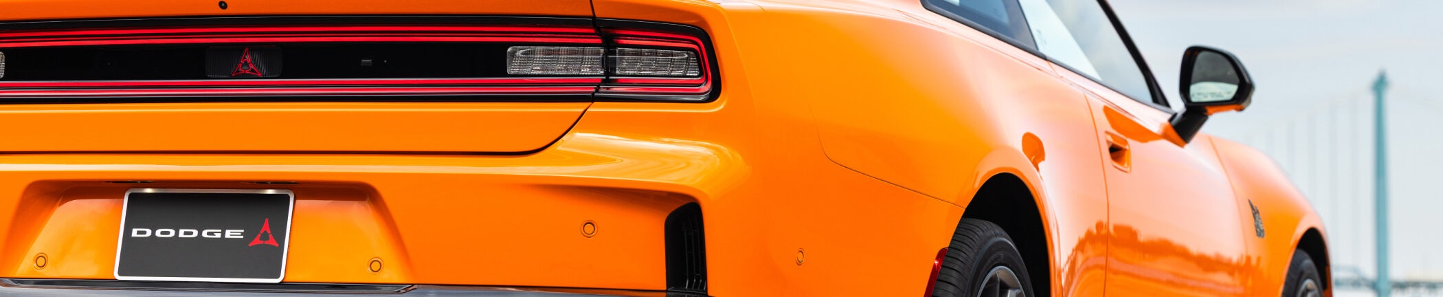 Rear view of an orange Dodge muscle car